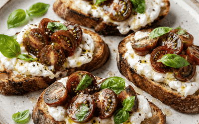 Bruschette con pomodoro ciliegino nero tigrato, stracciatella e basilico